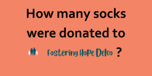 How many socks were donated to Fostering Hope Delco?
