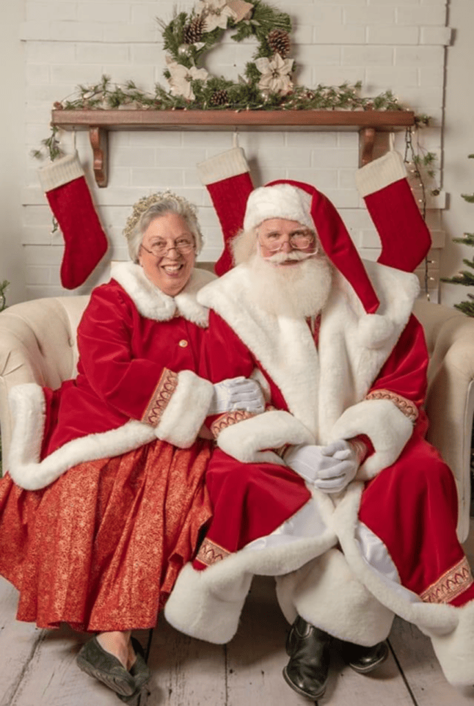 Santa and Mrs. Claus sitting on a couch